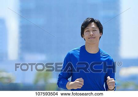 Young Japanese man running downtown Tokyo View Large Photo Image Picture - Young Japanese man running downtown Tokyo. Fotosearch