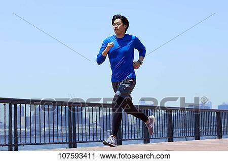 Young Japanese man running downtown Tokyo View Large Photo Image Stock Image - Young Japanese man running downtown Tokyo. Fotosearch