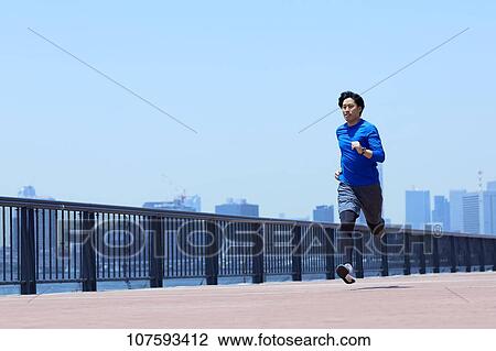 Young Japanese man running downtown Tokyo View Large Photo Image Stock Image - Young Japanese man running downtown Tokyo. Fotosearch