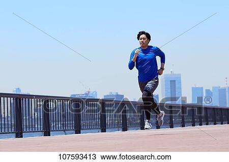 Young Japanese man running downtown Tokyo View Large Photo Image Stock Image - Young Japanese man running downtown Tokyo. Fotosearch