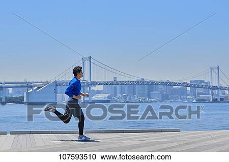 Young Japanese man running downtown Tokyo View Large Photo Image Stock Image - Young Japanese man running downtown Tokyo. Fotosearch