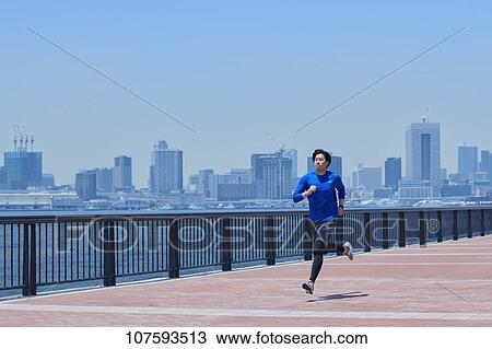 Young Japanese man running downtown Tokyo View Large Photo Image Stock Image - Young Japanese man running downtown Tokyo. Fotosearch
