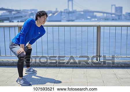Young Japanese man running downtown Tokyo View Large Photo Image Stock Image - Young Japanese man running downtown Tokyo. Fotosearch