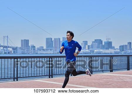 Young Japanese man running downtown Tokyo View Large Photo Image Stock Image - Young Japanese man running downtown Tokyo. Fotosearch