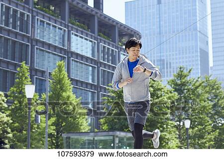 Young Japanese man running downtown Tokyo View Large Photo Image Stock Photo - Young Japanese man running downtown Tokyo. Fotosearch