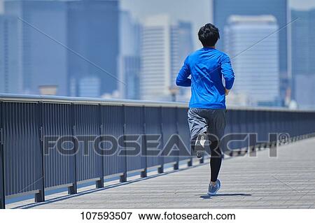 Young Japanese man running downtown Tokyo View Large Photo Image Stock Photo - Young Japanese man running downtown Tokyo. Fotosearch