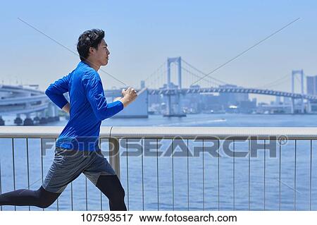 Young Japanese man running downtown Tokyo View Large Photo Image Stock Photo - Young Japanese man running downtown Tokyo. Fotosearch