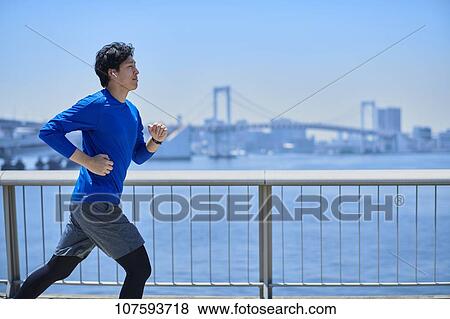 Young Japanese man running downtown Tokyo View Large Photo Image Stock Photo - Young Japanese man running downtown Tokyo. Fotosearch