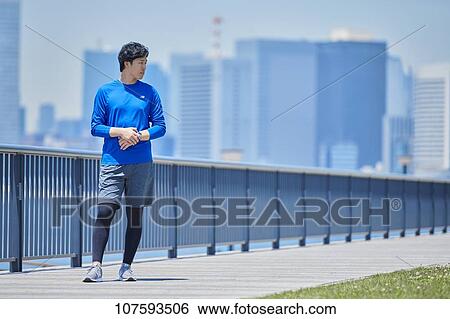 Young Japanese man running downtown Tokyo View Large Photo Image Stock Photograph - Young Japanese man running downtown Tokyo. Fotosearch