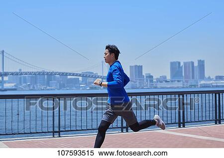 Young Japanese man running downtown Tokyo View Large Photo Image Stock Photography - Young Japanese man running downtown Tokyo. Fotosearch