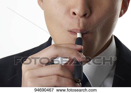 Young Japanese man smoking electronic cigarette View Large Photo Image Stock Photo - Young Japanese man smoking electronic cigarette. Fotosearch