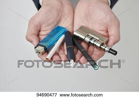 Stock Photo - Young Japanese man smoking electronic cigarette. Fotosearch