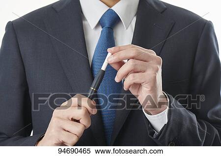 Stock Photography - Young Japanese man smoking electronic cigarette. Fotosearch