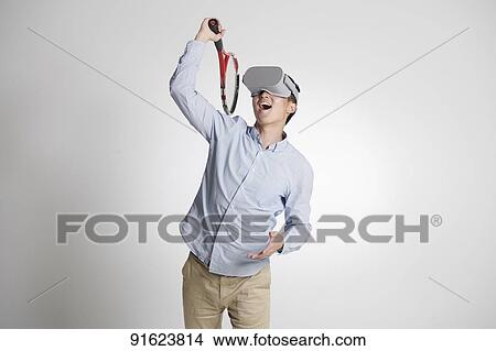 Young Japanese man using VR goggles View Large Photo Image Picture - Young Japanese man using VR goggles. Fotosearch