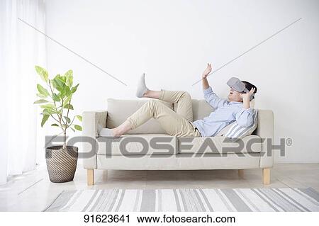 Young Japanese man using VR goggles View Large Photo Image Stock Image - Young Japanese man using VR goggles. Fotosearch
