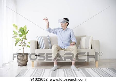 Young Japanese man using VR goggles View Large Photo Image Stock Image - Young Japanese man using VR goggles. Fotosearch