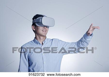 Young Japanese man using VR goggles View Large Photo Image Stock Image - Young Japanese man using VR goggles. Fotosearch