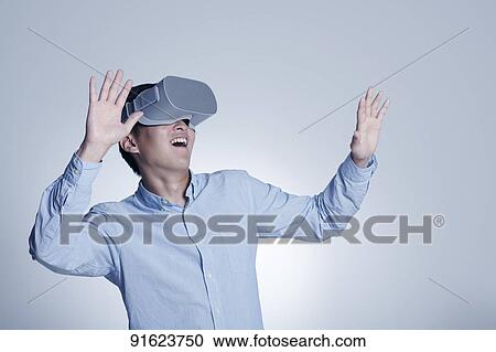 Young Japanese man using VR goggles View Large Photo Image Stock Image - Young Japanese man using VR goggles. Fotosearch