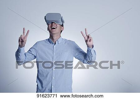 Young Japanese man using VR goggles View Large Photo Image Stock Image - Young Japanese man using VR goggles. Fotosearch