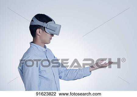 Young Japanese man using VR goggles View Large Photo Image Stock Image - Young Japanese man using VR goggles. Fotosearch