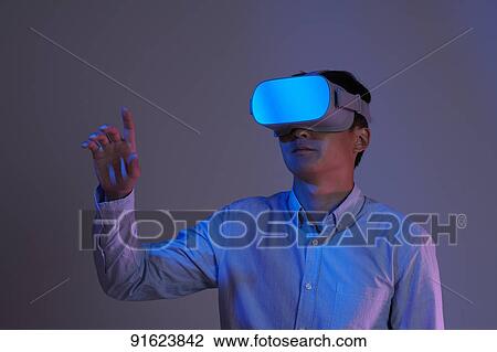 Young Japanese man using VR goggles View Large Photo Image Stock Image - Young Japanese man using VR goggles. Fotosearch