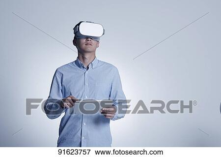 Young Japanese man using VR goggles View Large Photo Image Stock Photo - Young Japanese man using VR goggles. Fotosearch