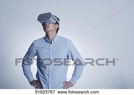Young Japanese man using VR goggles View Large Photo Image Stock Photo - Young Japanese man using VR goggles. Fotosearch