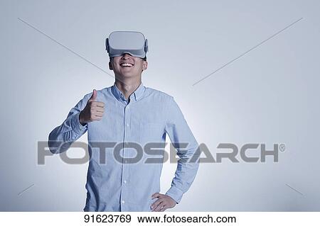 Young Japanese man using VR goggles View Large Photo Image Stock Photo - Young Japanese man using VR goggles. Fotosearch