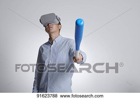 Young Japanese man using VR goggles View Large Photo Image Stock Photo - Young Japanese man using VR goggles. Fotosearch