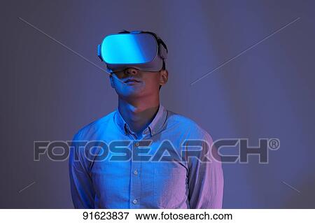 Young Japanese man using VR goggles View Large Photo Image Stock Photo - Young Japanese man using VR goggles. Fotosearch