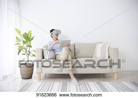 Young Japanese man using VR goggles View Large Photo Image Stock Photograph - Young Japanese man using VR goggles. Fotosearch
