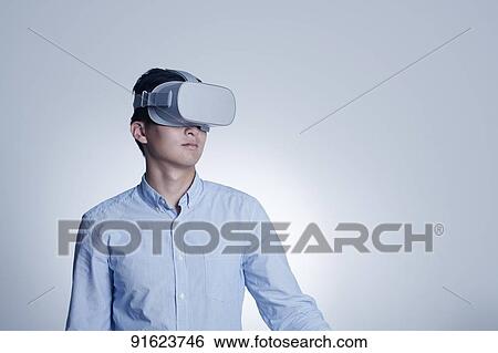 Young Japanese man using VR goggles View Large Photo Image Stock Photograph - Young Japanese man using VR goggles. Fotosearch
