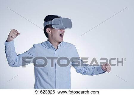 Young Japanese man using VR goggles View Large Photo Image Stock Photograph - Young Japanese man using VR goggles. Fotosearch