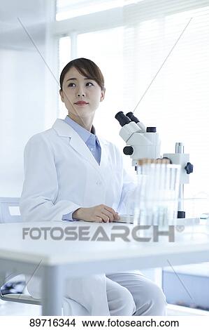 Picture - Young Japanese researcher in the lab. Fotosearch