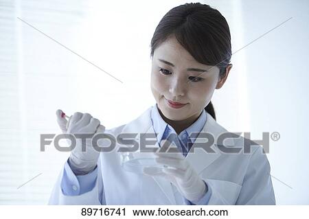 Young Japanese researcher in the lab View Large Photo Image Stock Image - Young Japanese researcher in the lab. Fotosearch