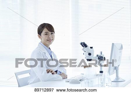 Stock Photo - Young Japanese researcher in the lab. Fotosearch