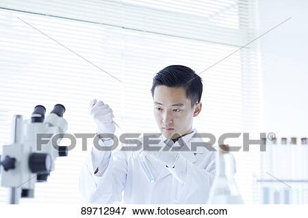 Young Japanese researcher in the lab View Large Photo Image Stock Photo - Young Japanese researcher in the lab. Fotosearch