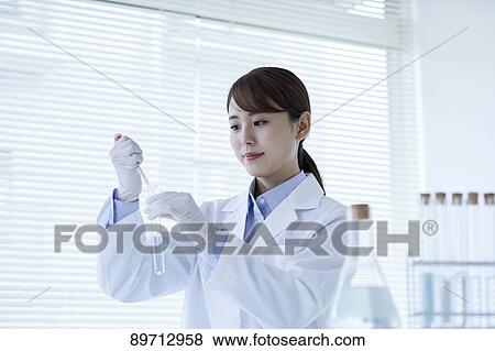 Young Japanese researcher in the lab View Large Photo Image Stock Photo - Young Japanese researcher in the lab. Fotosearch