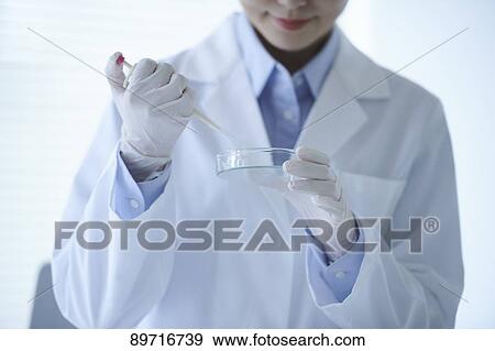 Stock Photo - Young Japanese researcher in the lab. Fotosearch
