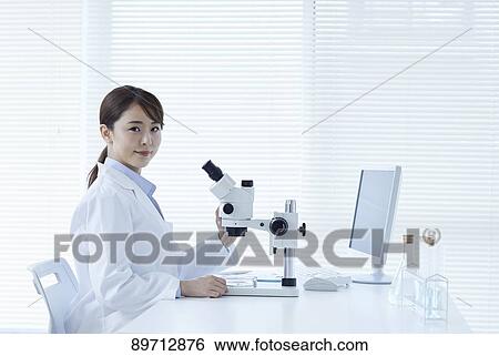 Stock Photograph - Young Japanese researcher in the lab. Fotosearch