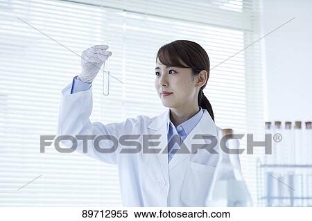 Stock Photography - Young Japanese researcher in the lab. Fotosearch