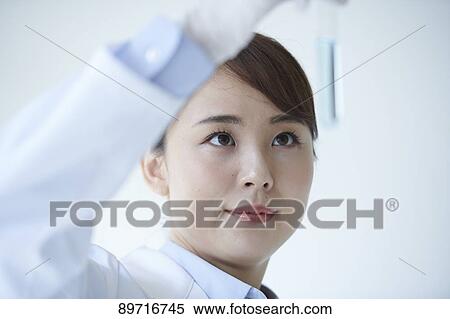 Stock Photography - Young Japanese researcher in the lab. Fotosearch