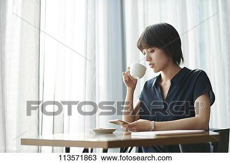 Young Japanese woman at a cafe View Large Photo Image Stock Image - Young Japanese woman at a cafe. Fotosearch