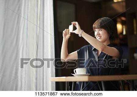 Young Japanese woman at a cafe View Large Photo Image Stock Photo - Young Japanese woman at a cafe. Fotosearch