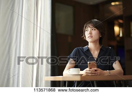 Young Japanese woman at a cafe View Large Photo Image Stock Photo - Young Japanese woman at a cafe. Fotosearch