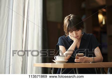 Young Japanese woman at a cafe View Large Photo Image Stock Photo - Young Japanese woman at a cafe. Fotosearch