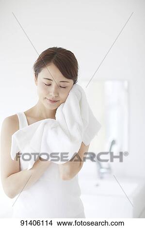 Picture - Young Japanese woman at home getting ready in the morning. Fotosearch