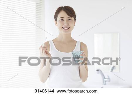 Young Japanese woman at home getting ready in the morning View Large Photo Image Picture - Young Japanese woman at home getting ready in the morning. Fotosearch