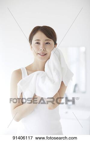 Stock Photo - Young Japanese woman at home getting ready in the morning. Fotosearch