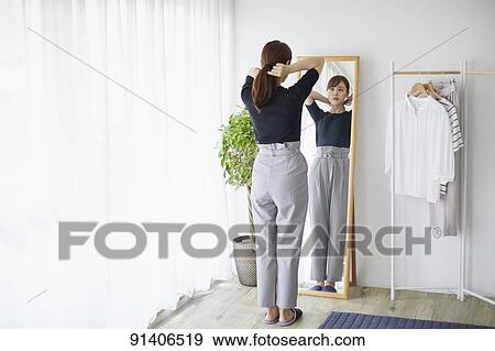 Young Japanese woman at home getting ready in the morning View Large Photo Image Stock Photo - Young Japanese woman at home getting ready in the morning. Fotosearch